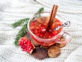 Fresh ripe pomegranate and red wine in a glass mug on a white knitted blanket Royalty Free Stock Photo