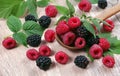 Fresh ripe raspberries and blackberries on a wooden table. summer healthy berries Royalty Free Stock Photo