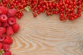 Fresh ripe raspberries and currand on wooden table Royalty Free Stock Photo