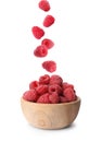 Fresh ripe raspberries falling into bowl on background Royalty Free Stock Photo