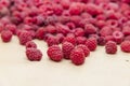 Fresh ripe raspberries scattered on light cardboard background Royalty Free Stock Photo