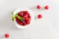 Fresh ripe raspberries in a white cup on white background. Top view, copy space. Natural cosmetics. Summer background, greeting Royalty Free Stock Photo