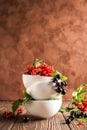 Fresh ripe red black currant berry in white bowls stand in a pile on the table. Selective focus. Vertical frame Royalty Free Stock Photo
