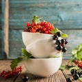 Fresh ripe red black currant berry in white bowls stand in a pile on the table. Square frame S Royalty Free Stock Photo