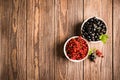 Fresh ripe red black currant berry in white bowls on wooden background. Horizontal frame. View from above. Royalty Free Stock Photo