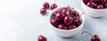 Fresh ripe red cherries in a white bowl on a gray stone background Closeup Horizontal banner Royalty Free Stock Photo