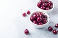 Fresh ripe red cherries in a white bowl on a gray stone background Closeup Royalty Free Stock Photo