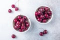 Fresh ripe red cherries in a white bowl on a gray stone background Closeup Water drops Royalty Free Stock Photo