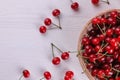 ripe red cherry in a basket on a white wooden table with a place for the inscription. top view Royalty Free Stock Photo