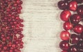 Fresh ripe red currants and cherries on rustic wood background. Royalty Free Stock Photo