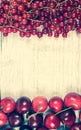 Fresh ripe red currants and cherries on rustic wood background. Royalty Free Stock Photo