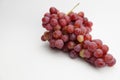 Fresh and ripe red grapes isolated in white background. Bunch of raw and juicy grapevines Royalty Free Stock Photo