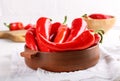 Fresh ripe red pepper in ceramic bowl on white table