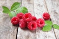 Fresh raspberries with leaves on a wooden background, closeup Royalty Free Stock Photo
