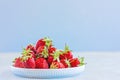 Fresh ripe red strawberries in a ceramic bowl on the table close-up. Selective focus. Space for text Royalty Free Stock Photo
