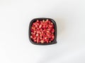 Fresh ripe red wild strawberries in a black plastic container on a white background. Top view. Copy space Royalty Free Stock Photo