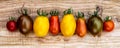 Fresh and ripe red and yellow cherry tomatoes on an old cutting board. Panoramic format Royalty Free Stock Photo