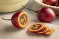 Fresh ripe sliced tamarillo close up on a cutting board