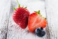 Fresh ripe strawberries and blueberries on plate on white Royalty Free Stock Photo