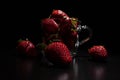 Fresh, ripe strawberries on dark background illuminated from above Royalty Free Stock Photo