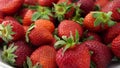 Fresh, ripe, strawberries rotate on plate.