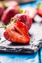 Fresh ripe strawberries washed with water on blue table Royalty Free Stock Photo