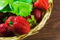 fresh ripe strawberries in wicker basket on old wooden background Royalty Free Stock Photo