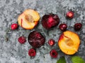 Fresh ripe summer berries and fruits, peaches, apricots, cherry and plum in a round plate on the table Royalty Free Stock Photo