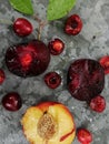 Fresh ripe summer berries and fruits, peaches, apricots, cherry and plum in a round plate on the table Royalty Free Stock Photo