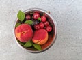 Fresh ripe summer berries and fruits, peaches, apricots, cherry and strawberry in a round plate Royalty Free Stock Photo