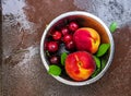 Fresh ripe summer berries and fruits, peaches, apricots, cherry and strawberry in a round plate Royalty Free Stock Photo