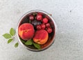 Fresh ripe summer berries and fruits, peaches, apricots, cherry and strawberry in a round plate Royalty Free Stock Photo