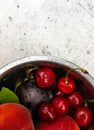 Fresh ripe summer berries and fruits, peaches, apricots, cherry and strawberry in a round plate Royalty Free Stock Photo