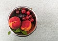 Fresh ripe summer berries and fruits, peaches, apricots, cherry and strawberry in a round plate Royalty Free Stock Photo