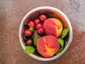 Fresh ripe summer berries and fruits, peaches, apricots, cherry and strawberry in a round plate Royalty Free Stock Photo