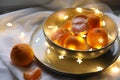 Fresh ripe tangerines and glowing fairy lights on white cloth