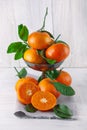 Fresh ripe tangerines, rustic food photography on white wood plate kitchen table Royalty Free Stock Photo