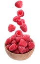 Fresh ripe tasty raspberries falling into bowl on background Royalty Free Stock Photo