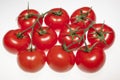 Fresh ripe tomatoes on the vine over white background Royalty Free Stock Photo