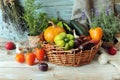 Fresh ripe vegetables and fruits in a basket, on a wooden table Royalty Free Stock Photo