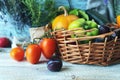 Fresh ripe vegetables and fruits in a basket, on a wooden table Royalty Free Stock Photo