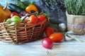 Fresh ripe vegetables and fruits in a basket, on a wooden table Royalty Free Stock Photo