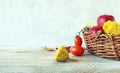 Fresh ripe vegetables and fruits in a basket, on a wooden table Royalty Free Stock Photo