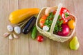 Fresh ripe vegetables and fruits in a wicker basket on a wooden table Royalty Free Stock Photo