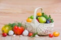 Fresh ripe vegetables and fruits in a wicker basket on a wooden table Royalty Free Stock Photo