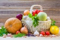 Fresh ripe vegetables in a wicker basket on a wooden table Royalty Free Stock Photo