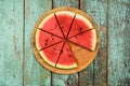 Fresh ripe watermelon cut in segments on shabby green table Royalty Free Stock Photo