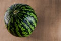 a fresh, ripe watermelon on a wooden board from a chopped angle. concept of summer eating