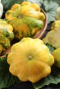 Fresh ripe yellow pattypan squashes with leaves on table, closeup Royalty Free Stock Photo