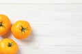 Fresh ripe yellow tomatoes on white wooden table, flat lay. Space for text Royalty Free Stock Photo